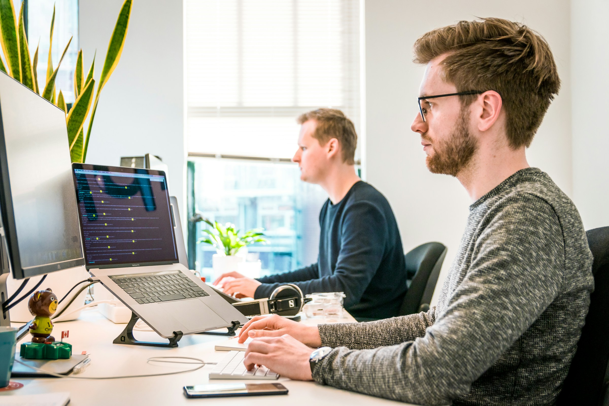 Two men working on their laptops. 